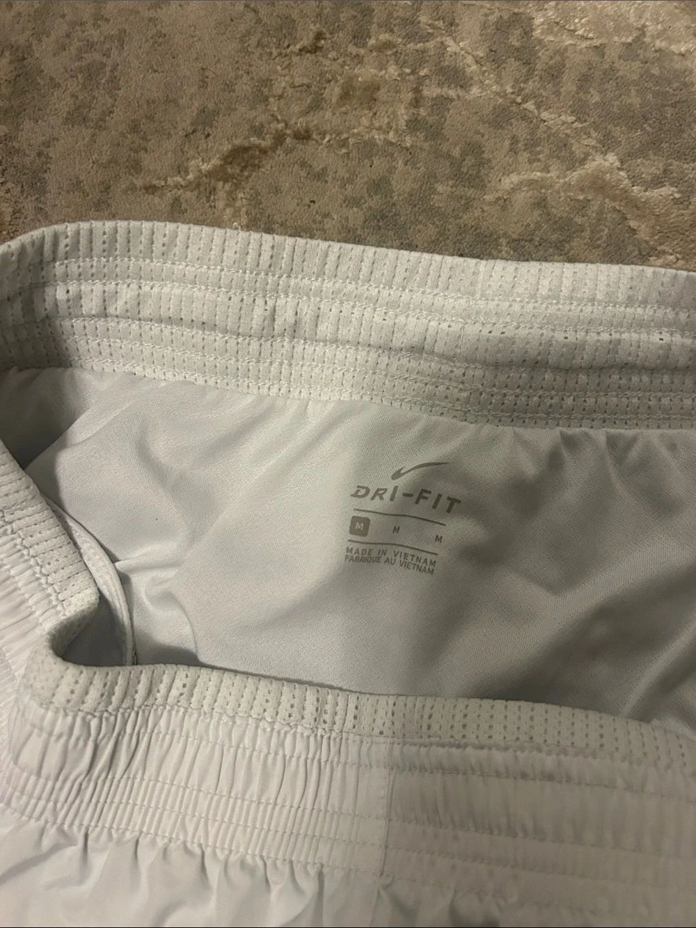 Nike Women's White Athletic Shorts with Silver Swoosh